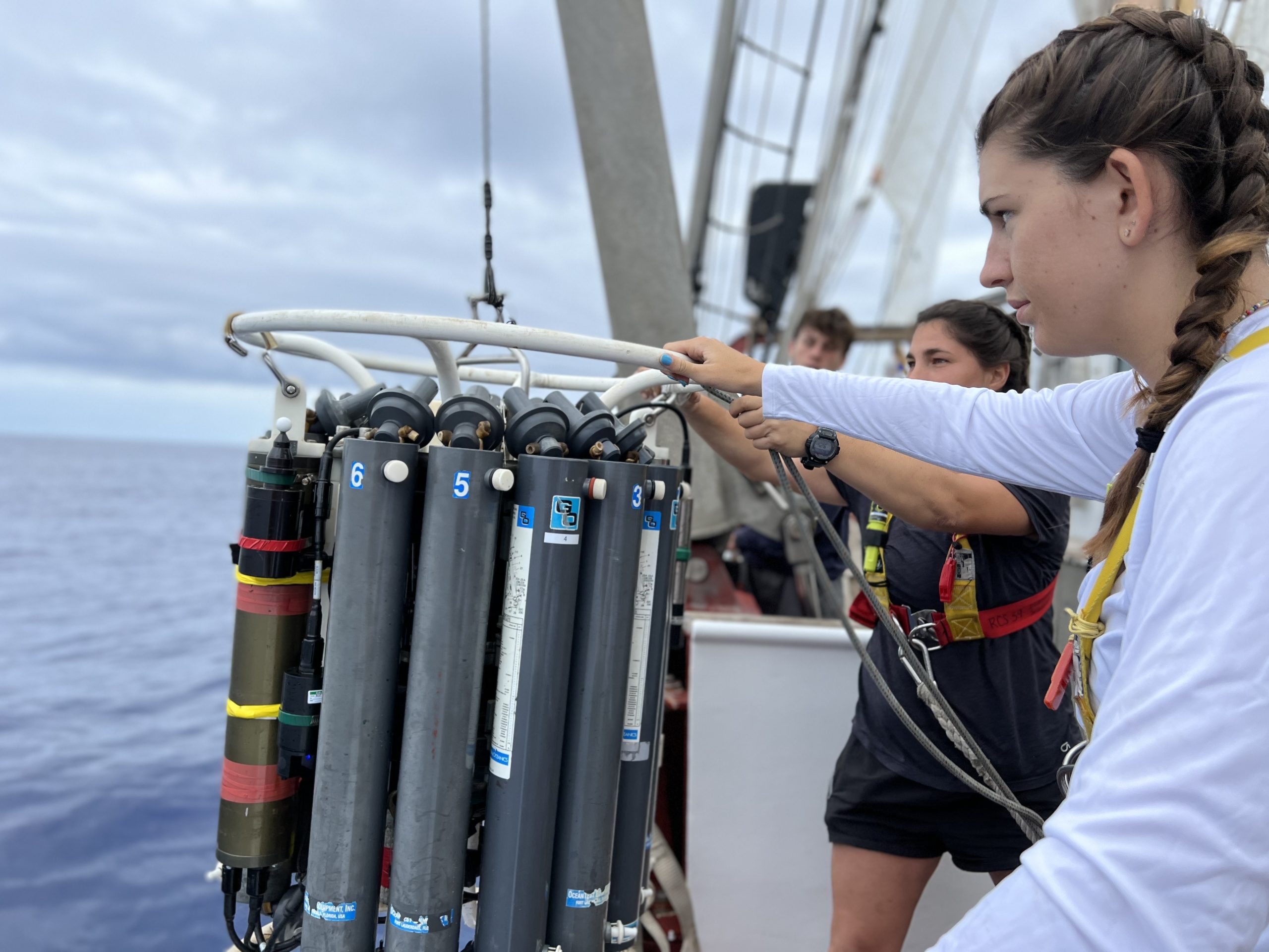 Brighton Hedger, Jordan Eckstein, and Diego Fernandez manage deploying the CTD for one of the first deployments of the voyage.